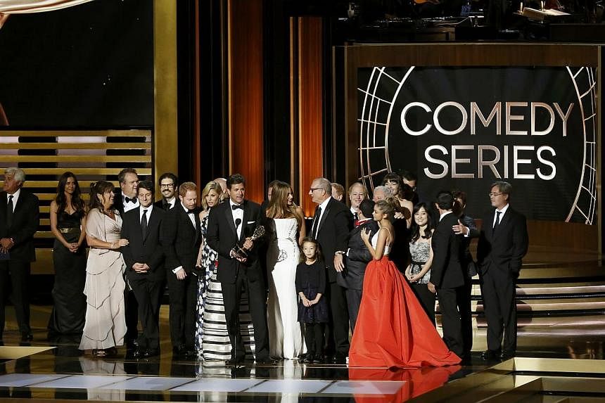 Show creator Steven Levitan (centre) with the cast and crew of Modern Family which won Outstanding Comedy Series at the 66th Annual Primetime Emmy Awards held at the Nokia Theatre. -- PHOTO: REUTERS