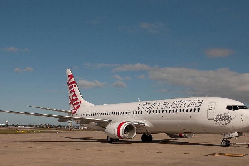 Passengers on Qantas and Virgin Australia are allowed from Tuesday to use mobile electronic devices in-flight with limited restrictions after a relaxation of the rules by the country's aviation authority. -- PHOTO: BLOOMBERG