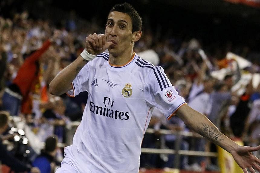In this file picture taken on April 16, 2014, Real Madrid's Argentinian midfielder Angel di Maria celebrates after scoring during the Spanish Copa del Rey (King's Cup) final football match against FC Barcelona at the Mestalla stadium in Valencia. -- 
