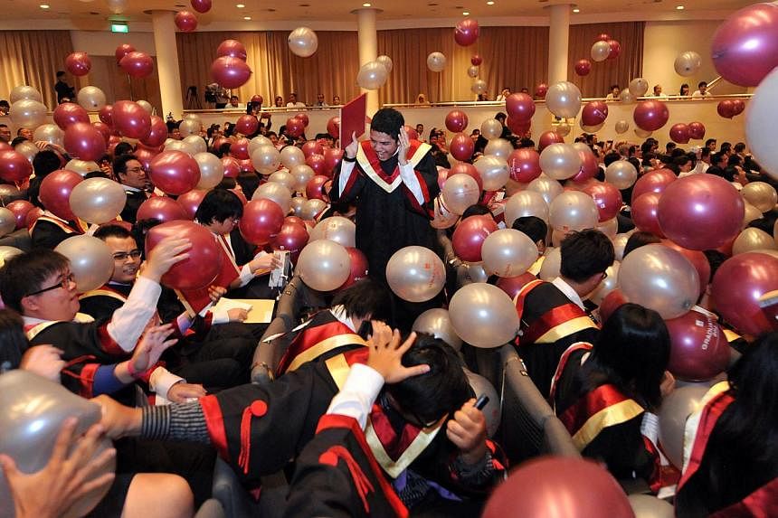 Institute of Technical Education (ITE) graduates don graduate gowns for the first time as they celebrated at their graduation ceremony held at the National University of Singapore’s University Cultural Centre hall. -- PHOTO: ST FILE