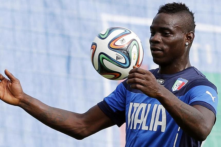 Italy's national soccer player Mario Balotelli in action at a training session during the 2014 World Cup. &nbsp;Liverpool completed the transfer of the AC Milan striker on Monday. August 25, 2014.&nbsp;&nbsp;-- PHOTO: REUTERS