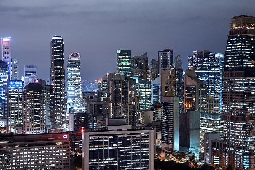 The Singapore Business District skyline at night as seen from 50th floor of The Pinnacle on Sept 19, 2013, showing the skyscrapers which house offices and banks.&nbsp;Takings for services firms in Singapore rose 2.8 per cent in the second quarter of 