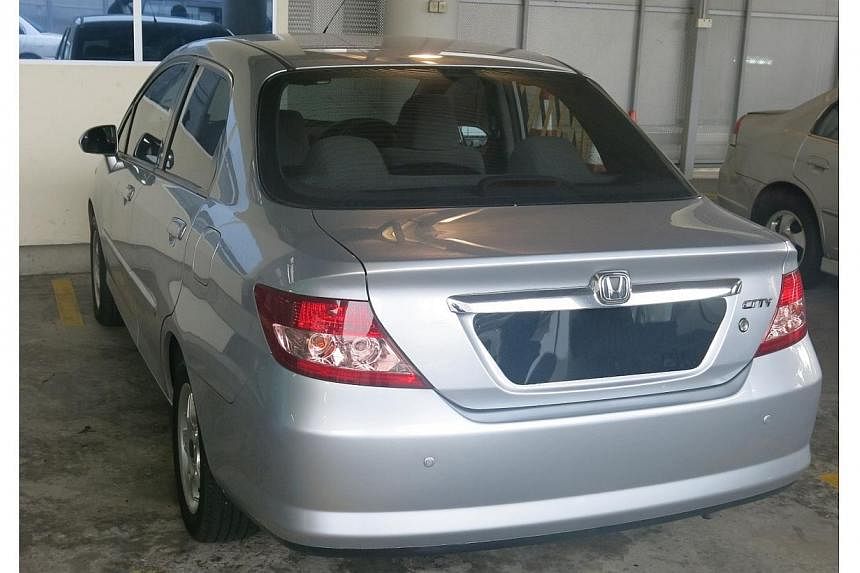 Singapore Customs officers seized the Malaysian-registered car (above) that was used to smuggle duty-unpaid cigarettes into Singapore at Woodlands Checkpoint. -- PHOTO: SINGAPORE CUSTOMS