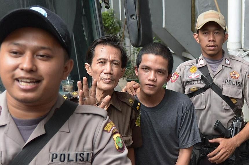 Indonesian cleaner Agun Iskandar (second right), one of five cleaners charged over allegations of sexual assault, arrives at the South Jakarta Court in Jakarta on Aug 26, 2014.&nbsp;Four cleaners were charged in court Wednesday, Aug 27, 2014, over th