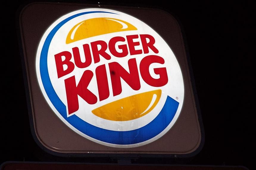An illuminated Burger King sign is seen in Washington, DC on Aug 25, 2014. -- PHOTO: AFP&nbsp;
