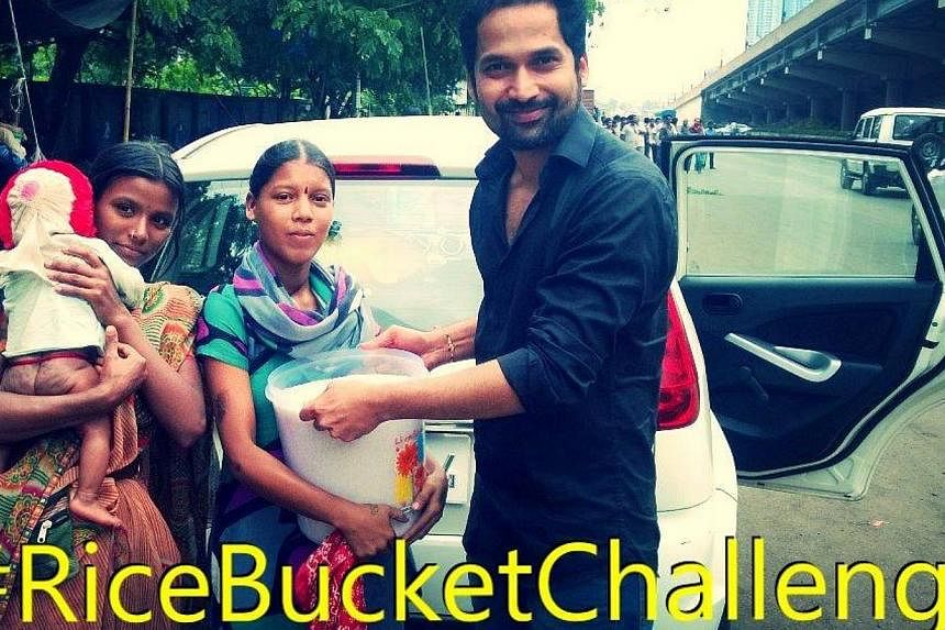 Since the launch of the Rice Bucket Challange on Aug 22, the campaign has attracted 138,000 contributors, one of whom is shown in this picture. -- PHOTO: FACEBOOK PAGE OF RICE BUCKET CHALLENGE