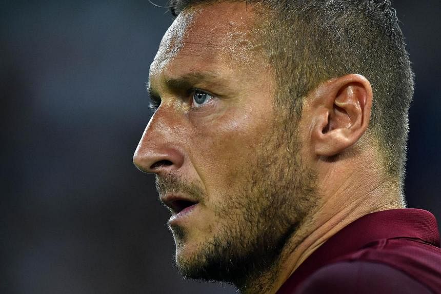 Roma legend Francesco Totti may be one of the best strikers of his time with his silky playing style, but he's not immune to a bout of clumsiness from time to time. -- PHOTO: AFP