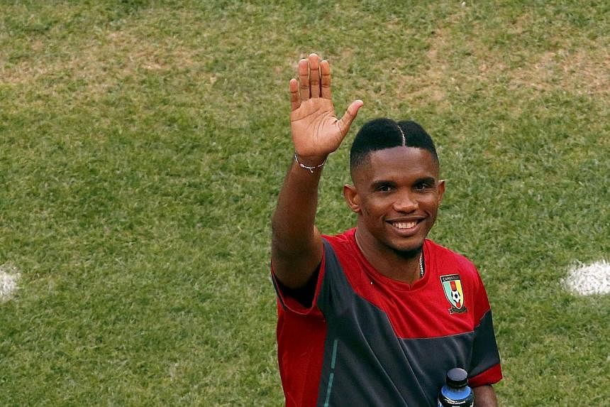 Cameroon's Samuel Eto'o waves to a supporter in the stands during a team soccer training session at the national stadium in Brasilia ahead of their 2014 World Cup Group A soccer match against Brazil on June 22, 2014. -- PHOTO: REUTERS