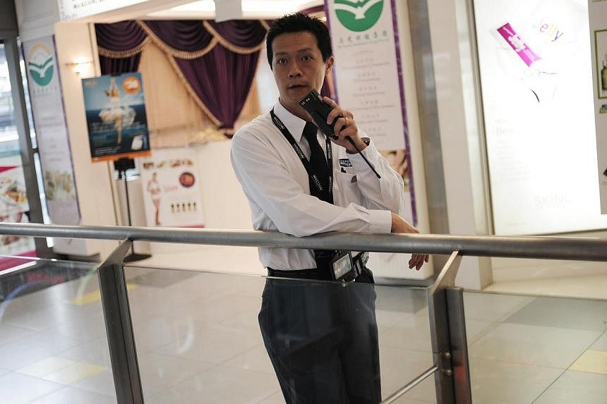 A security guard on patrol at Nex shopping mall on&nbsp;Dec 5, 2012. Security guards can look forward to a possible increase of at least $300 in basic monthly pay from as early as October.&nbsp;-- PHOTO: ST FILE