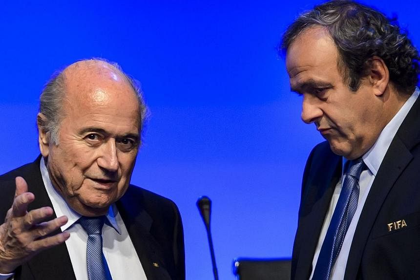 Fifa president Sepp Blatter (left) talks to Uefa president Michel Platini during the 64th Fifa congress on June 11, 2014 in Sao Paulo, on the eve of the opening match of the 2014 Fifa World Cup in Brazil. Platini will not stand for election as presid