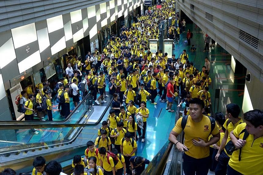 ACS (I) students get off the train at Stadium station on the Circle Line.&nbsp;Transport operator SMRT's decision to allow Anglo-Chinese School (Independent) to charter five MRT trains to ferry some 3,000 students to a rugby match has sparked a debat