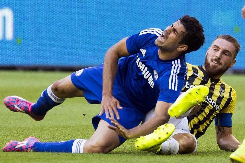 Chelsea's Diego Costa (left) fights for the ball with Vitesse Arnhem's Guram Kashia during their friendly football match in Arnhem on July 30, 2014.&nbsp;-- PHOTO: REUTERS