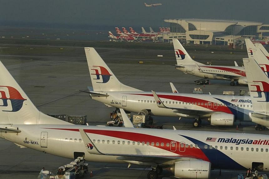 Shares in Malaysia Airlines (MAS) will be suspended on Friday, Aug 29, 2014, ahead of the announcement of its planned restructuring by a state investment fund, a source with knowledge of the plans told Reuters. -- PHOTO: REUTERS