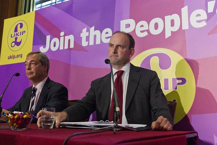 Former British Conservative Party MP Douglas Carswell (right) addresses a press conference in central London on Aug 28, 2014, with UKIP Party leader Nigel Farage (left).&nbsp;-- PHOTO: AFP