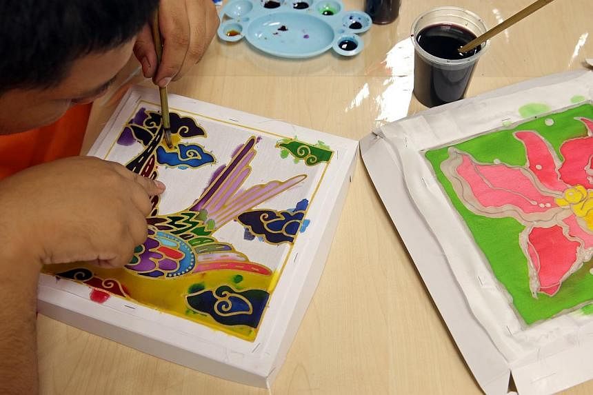 Djohan bin Mohd Sani, 26, adds colour to a batik print. He is among the eight beneficiaries from Cerebral Palsy Alliance Singapore (CPAS), who attended the 10th and also the last batik painting workshop conducted by local visual artist, Kamal Dollah 