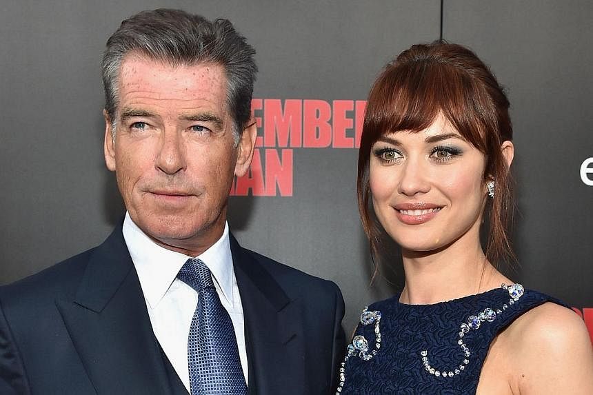 Co-stars Pierce Brosnan and Olga Kurylenko (both above) at the premiere of November Man (left), which Brosnan produced and acted in.