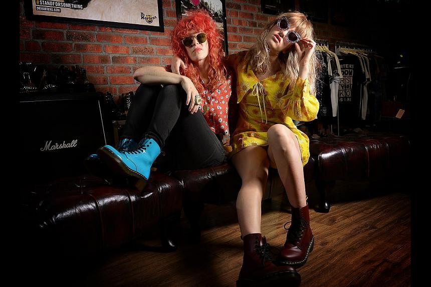 Deap Vally's Julie Edwards (left) on how she first met bandmate Lindsey Troy (right). -- ST PHOTO: DESMOND WEE