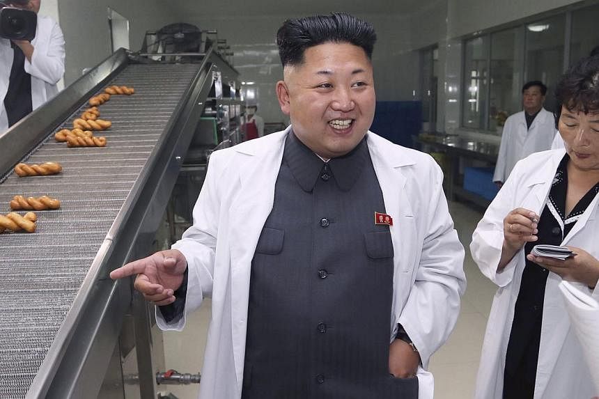 North Korean leader Kim Jong Un smiles as he gives field guidance during a visit to the November 2 Factory of the Korean People's Army (KPA). -- PHOTO: REUTERS