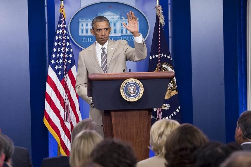 Much ado over a suit instead of the Syria crisis.&nbsp;US President Barack Obama departs the White House Press Briefing Room after addressing reporters in Washington. &nbsp;-- PHOTO: AFP