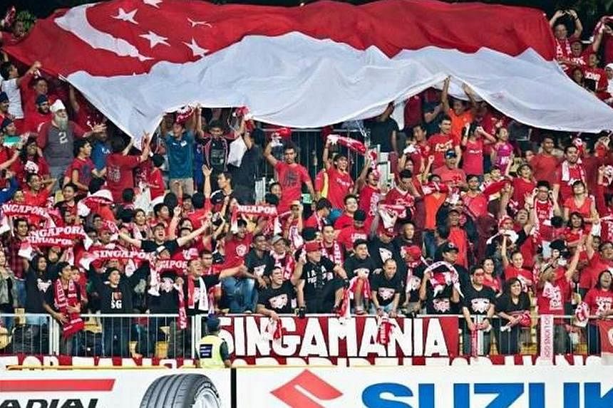 Members of Singamania, a fan club for the national football team, showing their support during an AFF Suzuki Cup match at Jalan Besar Stadium. The Lions created history by winning their fourth title in the AFF Suzuki Cup football tournament in Bangko