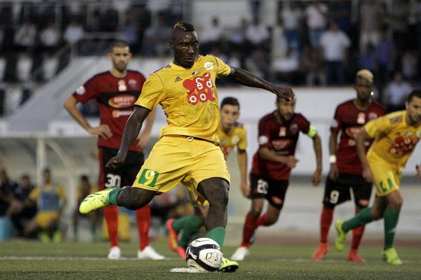 JS Kabylie's Cameroonian striker Albert Ebosse (centre) converts a penalty during his team's match with USM Alger in the city of Tizi-Ouzou, in the mainly Berber region of Kabylie east of the capital, on August 23, 2014. Ebosse died on August 23, aft