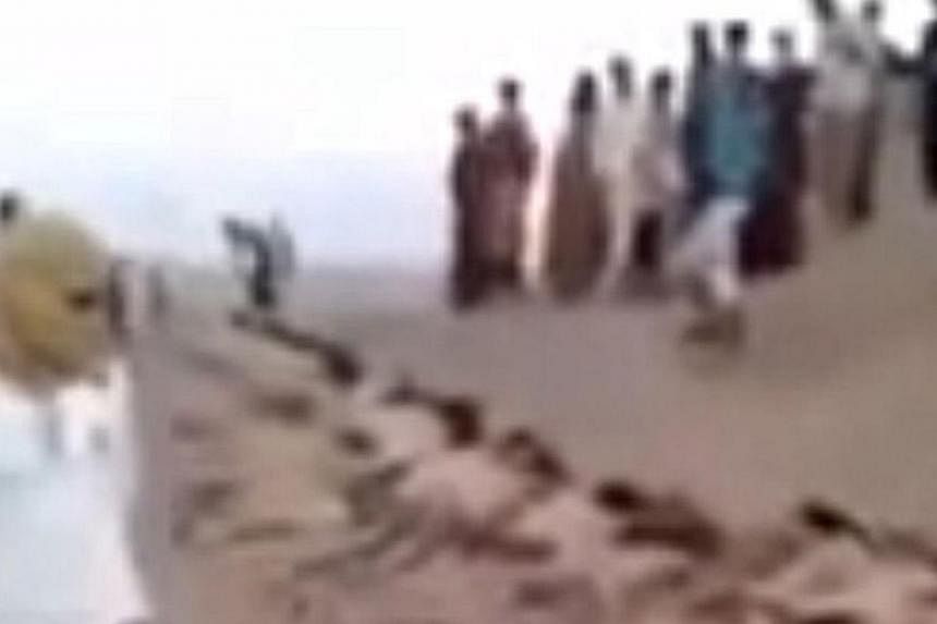 An image grab taken from a video uploaded on social networks on August 28, 2014, shows young men in underwear lying on the ground after being allegedly executed on August 27, 2014 by Islamic State militants at an undisclosed location in Syria's Raqa 