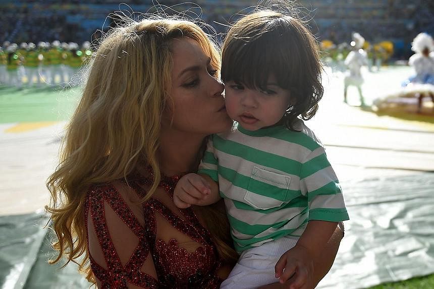 Colombian singer Shakira kisses her son Milan at this year's FIFA World Cup in Rio de Janeiro in July 2014. The pop star&nbsp;is expecting her second child with Spanish footballer Gerard Pique, she said in an interview published Thursday. -- PHOTO: A