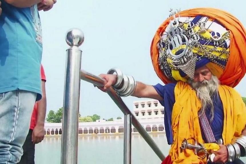 Mr&nbsp;Avtar Singh Mauni, who lives in Punjab, takes six hours to put on his headdress, which stretches to 645m when unwrapped - the length of around six football fields.&nbsp;-- PHOTO: BARCROFT TV/YOUTUBE