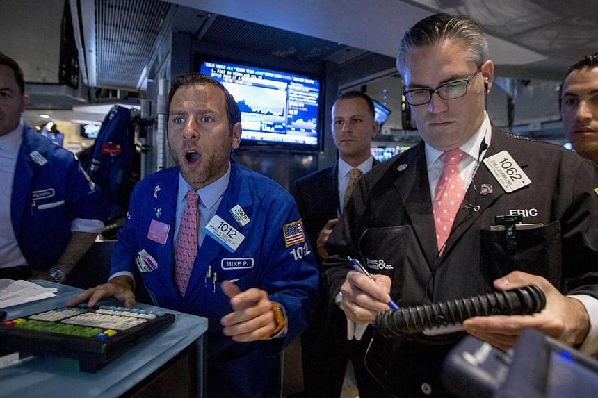 Specialist trader Michael Pistillo (second from left) gives a price for a stock just after the opening bell on the floor of the New York Stock Exchange on August 28, 2014. US stocks fell modestly on Thursday as rising fears about renewed tensions bet