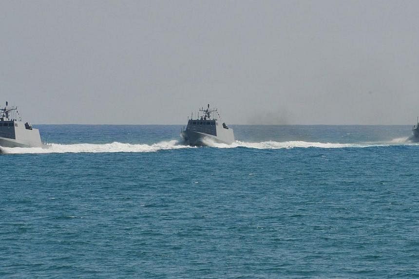 Three Taiwanese-built missile boats take part in an exercise in waters off the southern naval base of Tsoying on July 21, 2014. Taiwan plans to spend NT$74.8 billion (S$3.12 billion) in the next nine years to acquire anti-missile systems to boost its