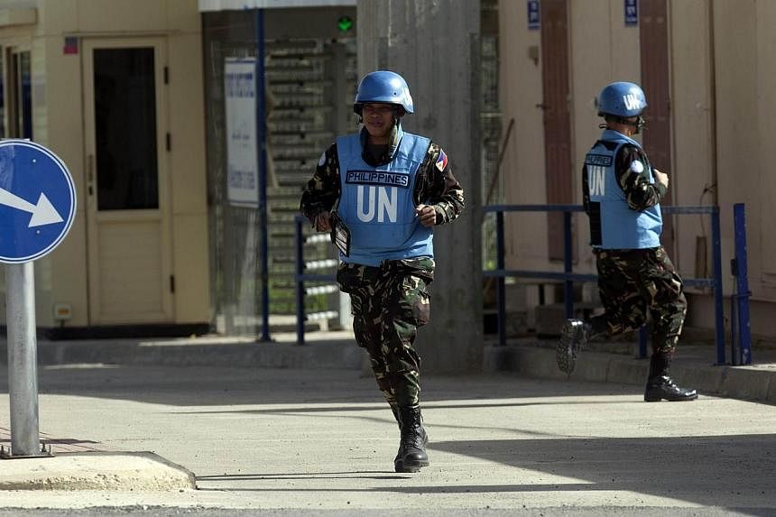 Filipino UN peacekeepers cross the Quneitra checkpoint between Israel and Syria in the Golan Heights on March 9, 2013.&nbsp;Philippine soldiers serving as UN peacekeepers in the Golan Heights clashed with Syrian rebels, Defence Minister Voltaire Gazm