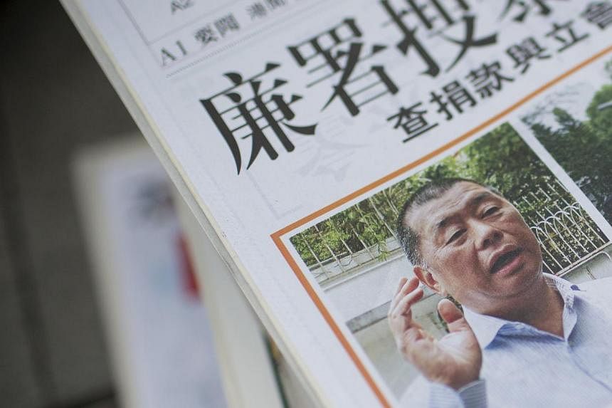 A copy of Ming Pao Daily newspaper featuring media tycoon Jimmy Lai after his Kowloon home was searched by officers on Thursday.