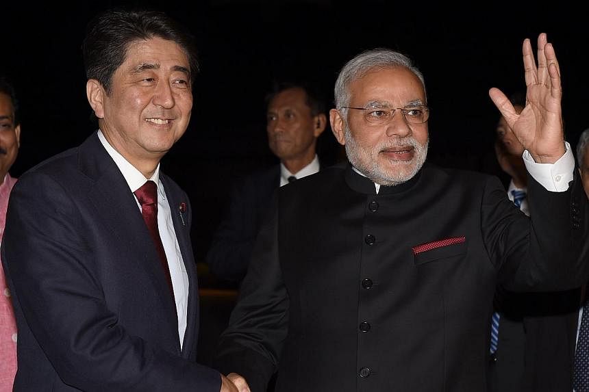 India's new Prime Minister Narendra Modi (front, right) is welcomed by his Japanese counterpart Shinzo Abe upon his arrival at the State Guest House in Kyoto, western Japan on Aug 30, 2014. -- PHOTO: AFP