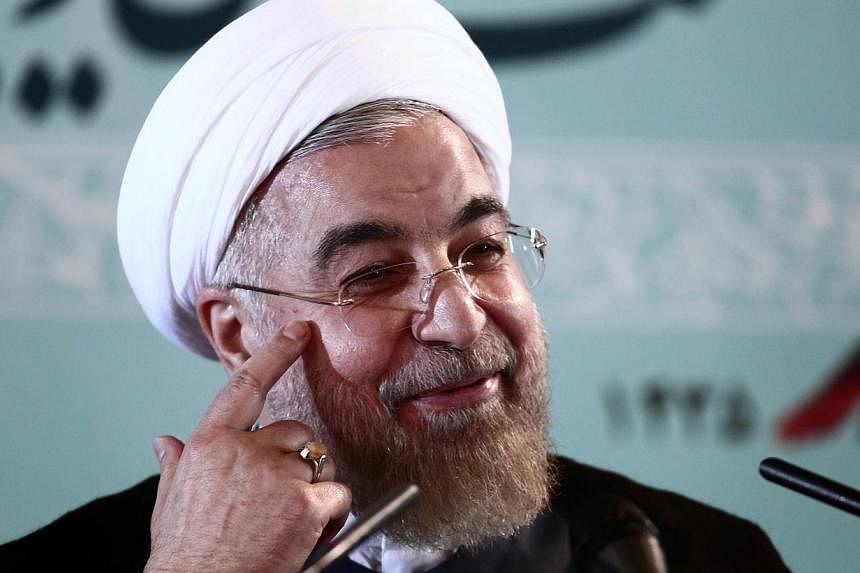 Iranian President Hassan Rouhani gestures during a press conference in Teheran on August 30, 2014. Iran accused the United States of duplicity for imposing new sanctions on organisations linked to Teheran's nuclear programme, despite long-running but