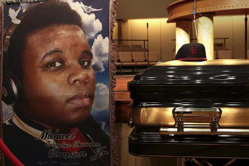 A baseball cap and a portrait of Michael Brown are shown alongside his casket inside Friendly Temple Missionary Baptist Church before the start of his funeral service in St Louis, Missouri on August 25, 2014. Teenager Brown&nbsp;was shot dead by a wh