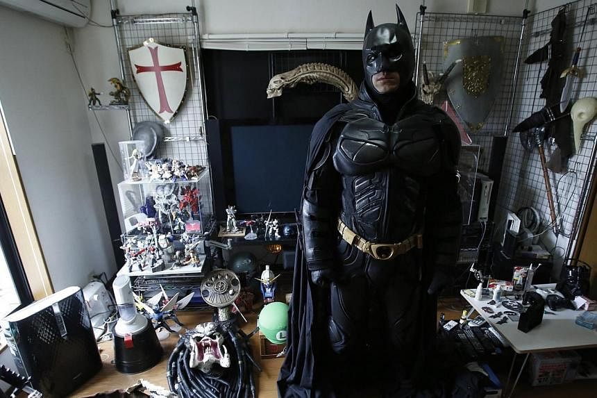A 41-year-old man going by the name of Chibatman poses in his room before going on the road on his "Chibatpod" in Chiba, east of Tokyo, Aug 31, 2014.&nbsp;A man who dresses up like the Dark Knight and zips around Chiba sprawled on a three-wheeled mot