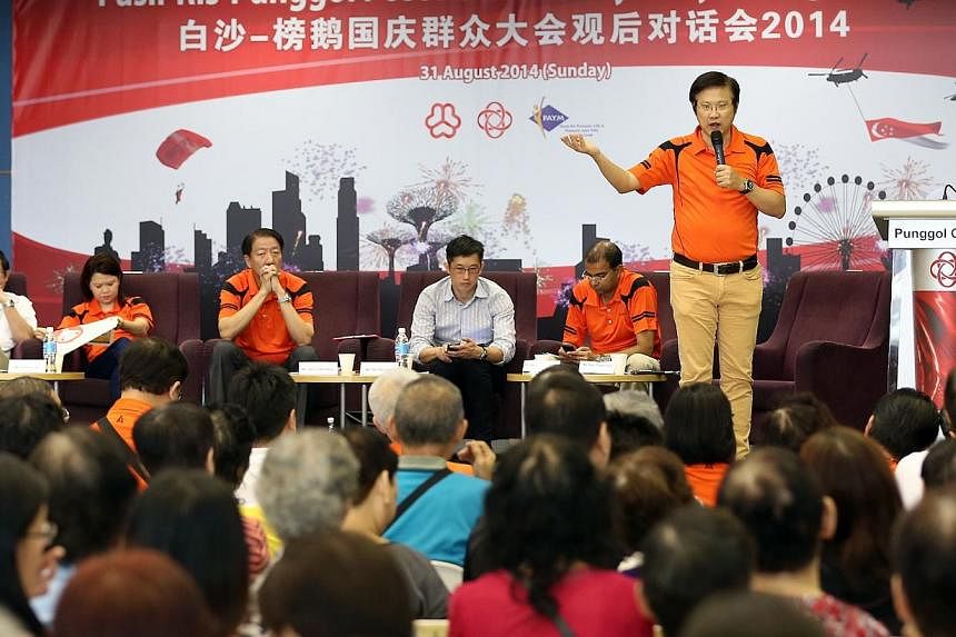 MP for Pasir Ris-Punggol GRC Gan Thiam Poh (standing up) addresses the residents on the lease buyback scheme during a Pasir Ris-Punggol post National Day Rally dialogue session held at the Sengkang Community Club's multi-purpose hall on Aug 31, 2014.