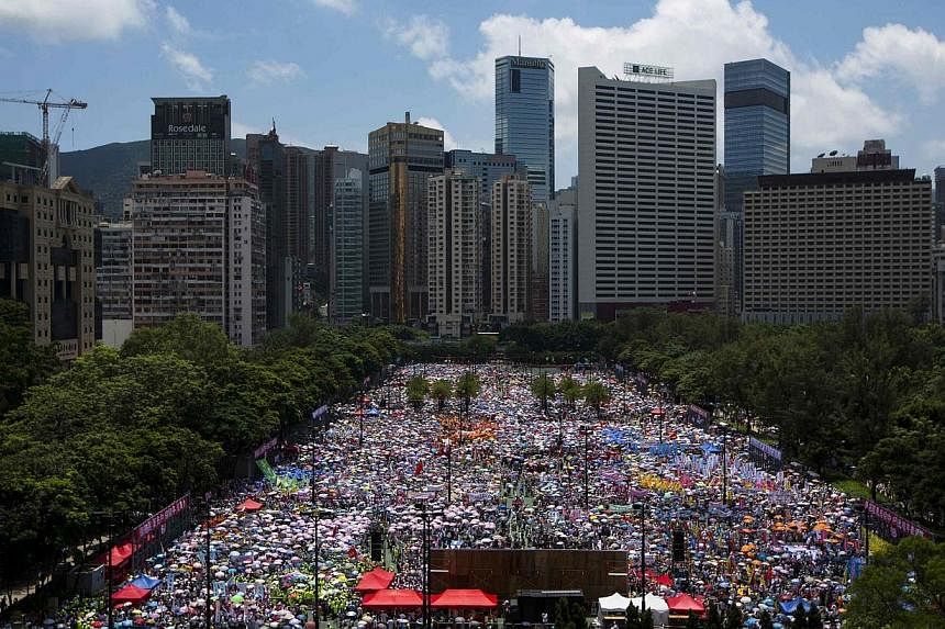 Thousands of pro-Beijing protesters gather to march in the streets against a pro-democracy Occupy Central campaign in Hong Kong on Aug 17, 2014. -- PHOTO: REUTERS