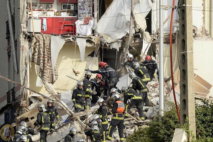 French firefighters search through the rubble of a four-storey residential building that collapsed following a blast in Rosny-sous-Bois in the eastern suburbs of Paris on Aug 31, 2014. -- PHOTO: AFP