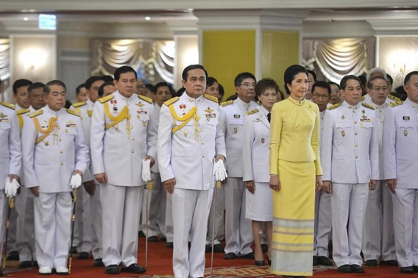 Thailand's newly appointed Prime Minister Prayuth Chan-ocha (centre) stands with his wife Naraporn during the royal endorsement ceremony at the Royal Army headquarters in Bangkok on Aug 25, 2014.&nbsp;Thailand's coup leader and newly appointed premie