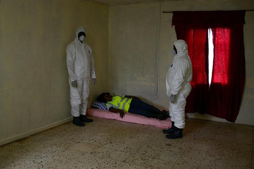 An Ebola prevention drill at a port in Liberia's capital Monrovia. Experts said the outbreak will not end until people calm down and help their infected neighbours instead of fleeing from them.