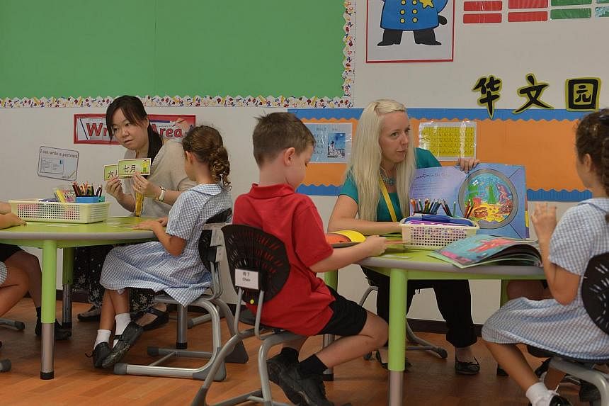 Mandarin language teacher Meow Cheng Ng (left) and English language teacher Colette Hall Grey (right) conducting lessons for a class of six-year-olds in Dulwich College. One of the main draws of the school is its emphasis on Mandarin.