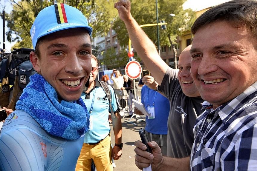 Belgian cycling star Igor Decraene (left) celebrates with his father (right) on September 24, 2013 after winning the men's juniors time trial race at the World Cycling championships in Florence. Belgium cycling lost one of its budding stars on August