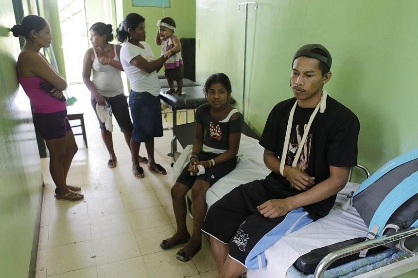 A rescued miner (right) waits to be discharged from hospital to go back home, in Bonanza, northeastern Nicaragua, on August 30, 2014. Rescuers in Nicaragua on Friday rescued 20 miners who had been trapped deep underground for nearly two days after a 