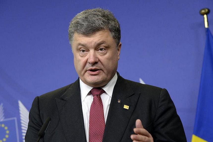 President of Ukraine Petro Poroshenko gives a press conference following his meeting with the European commission president at the EU Council building in Brussels on August 30, 2014. He said on Saturday he believed that efforts to halt violence with 