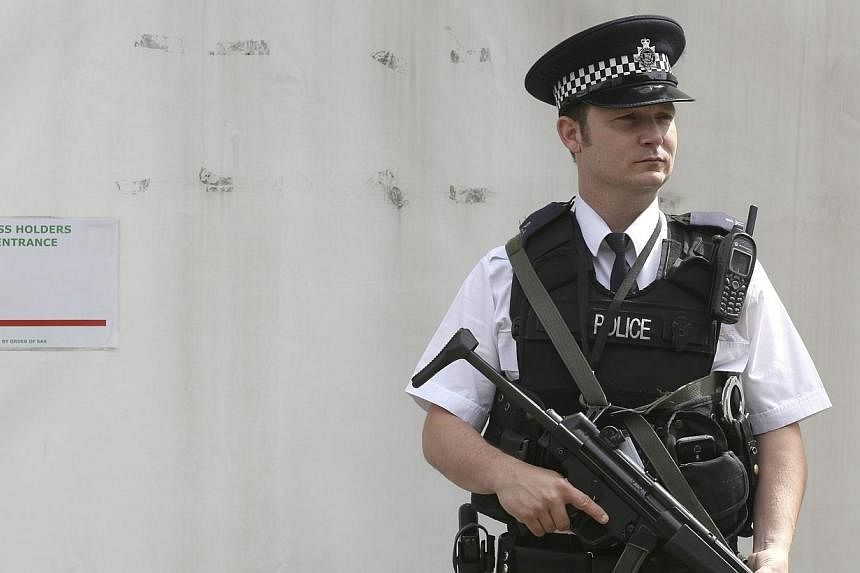 An armed police officer is seen on duty outside the Houses of Parliament in central London on Aug 30, 2014.&nbsp;British Prime Minister David Cameron was to outline tougher measures against jihadist suspects on Monday after Britain raised its securit
