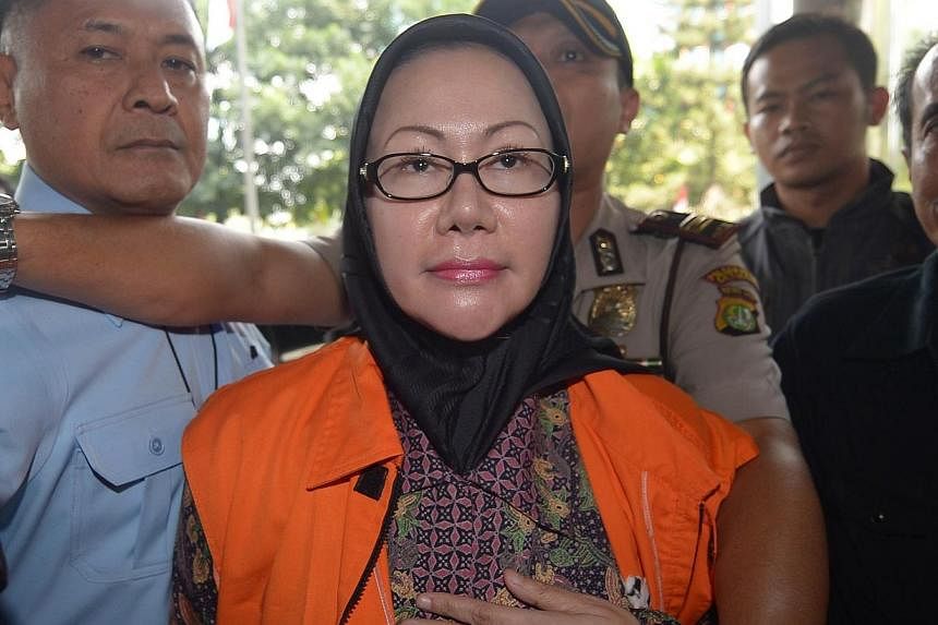 Indonesian Ratu Atut Chosiyah arrives at a court prior to her trial in Jakarta on Sept 1, 2014. -- PHOTO: AFP