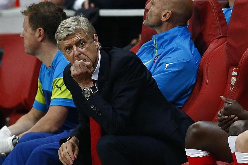 Arsenal manager Arsene Wenger reacts during their Champions League playoff football match against Besiktas at the Emirates stadium in London on Aug 27, 2014.&nbsp;-- PHOTO: REUTERS