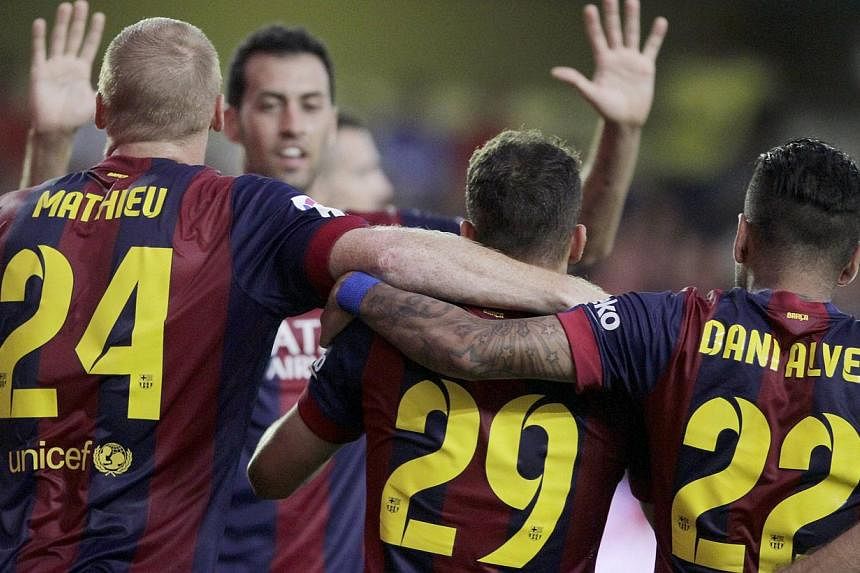 Barcelona's players celebrate after Sandro Ramirez (2nd right) scored against Villarreal during their Spanish first division soccer match at the Madrigal stadium in Villarreal August 31, 2014. -- PHOTO: REUTERS