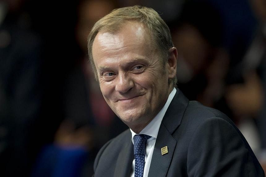 Polish Prime Minister and EU Council president-elect Donald Tusk attends a press briefing at the European Union summit at the EU Headquarters in Brussels. -- PHOTO: AFP